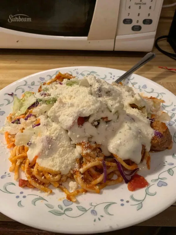 Palate puzzles exploring bizarre food pairings that challenge your taste buds - #19 Spaghetti and meatballs topped with salad and ranch.