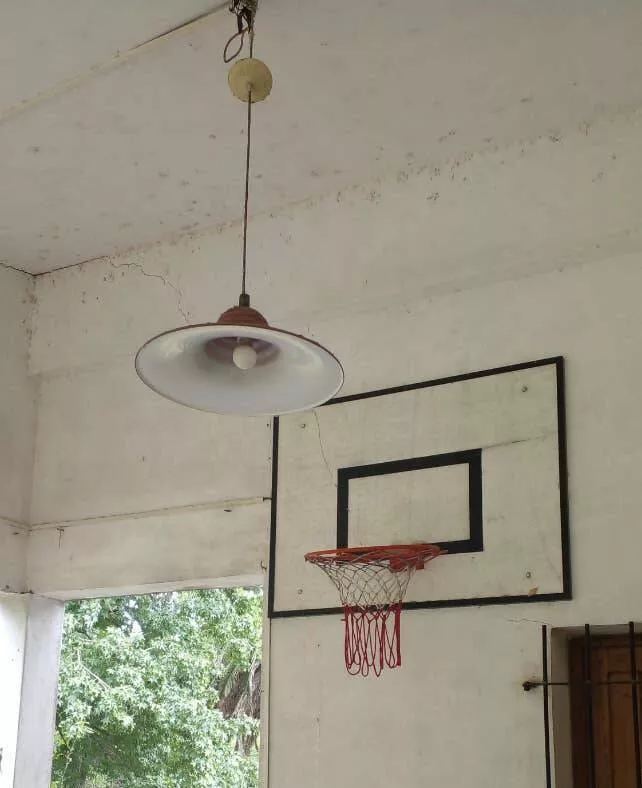 Workplace whimsies unveiling the comedy of errors in ridiculous office mishaps - #12 Whoever installed this light and basketball net *right* by each other (aka an accident just waiting to happen):
